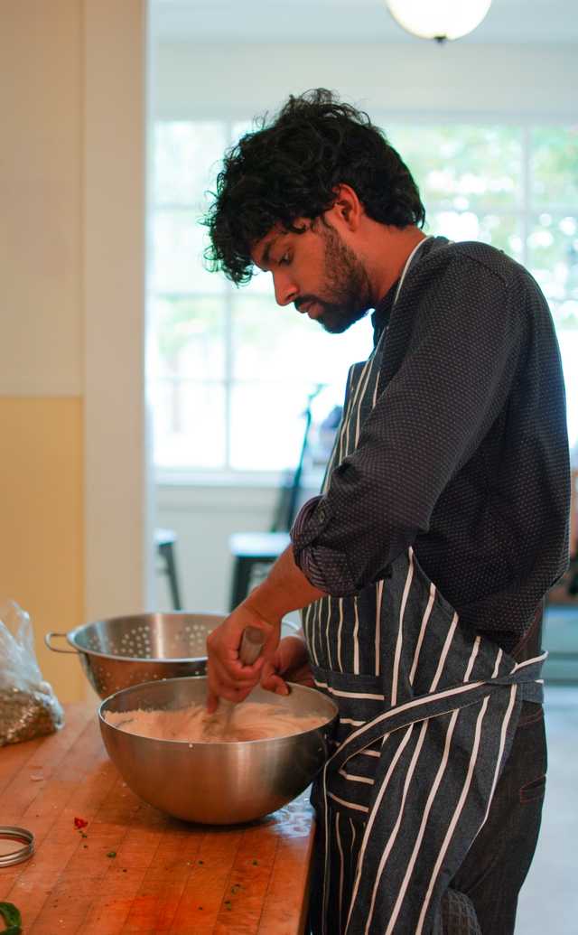 A person stirring ingredients in a bowl.