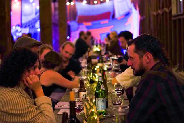 A group of people mingling over dinner.