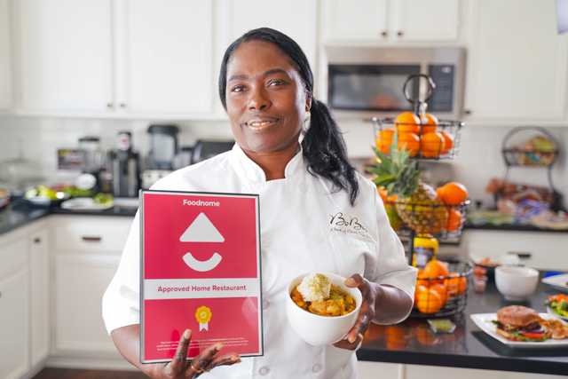 Woman holding foodnome certificate