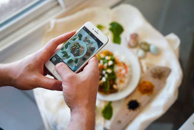 A person taking food photography.