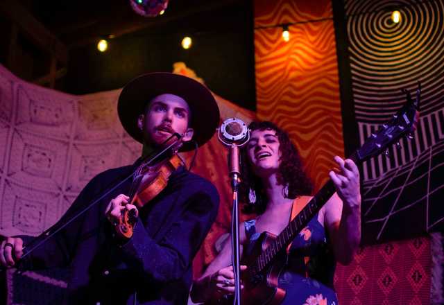 Maya Elise singing and M'Gilvry Allen playing violin