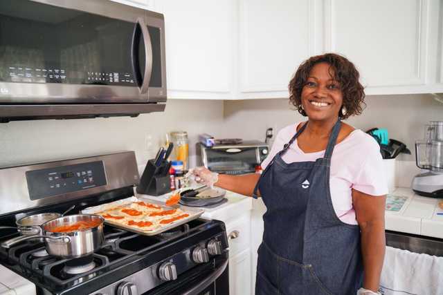 Woman cooking and smiling