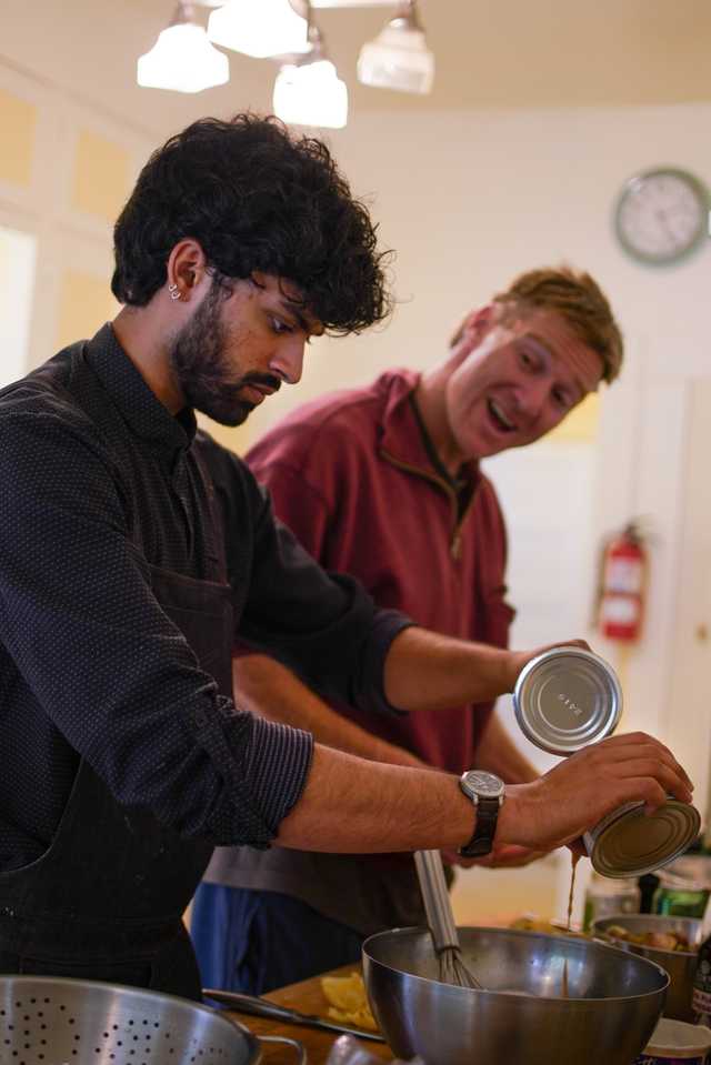 A person preparing food from a can.